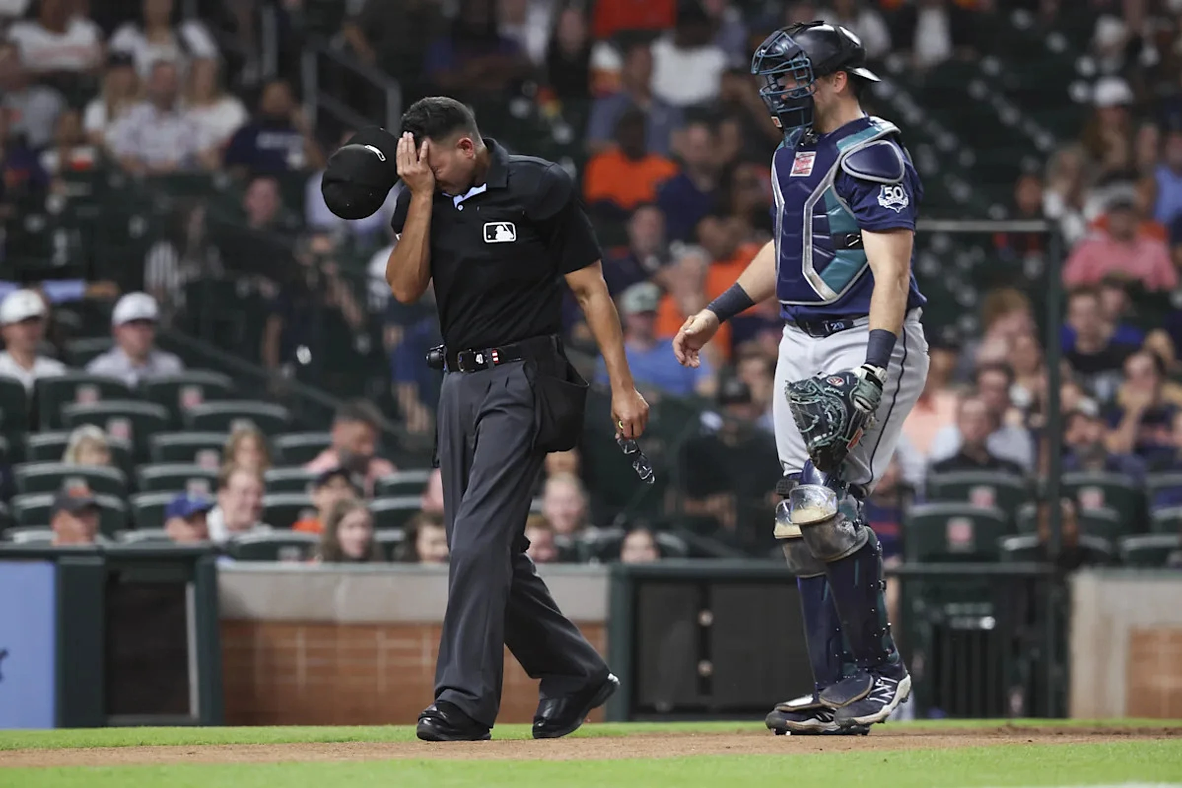 Mariners lose game, umpire, maybe Cal Raleigh in extras